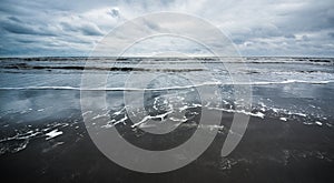 Caspian sea under blue sky in early September, snag on the beach