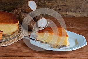 Cassava cake on wooden background. Cut piece