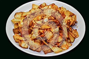 Cassava chips on black background