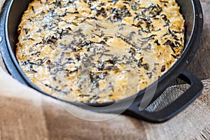 Casserole with cheese and herbs in metallic form