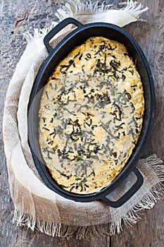 Casserole with cheese and herbs in metallic form