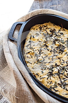 Casserole with cheese and herbs in metallic form