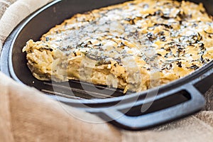 Casserole with cheese and herbs in metallic form