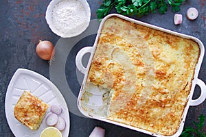 Casserole with fish on dark tabble