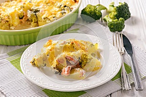 Casserole with fish salmon, potatoes and broccoli.