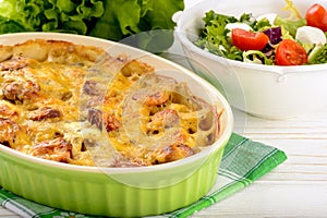 Casserole with potatoes, sausages, tomatoes and cheese.