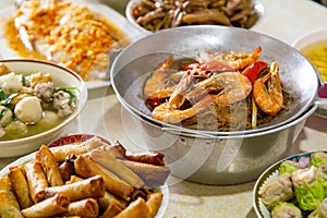 Casseroled prawns with Glass Noodels in Small Iron Pan with Fish, Fried Spring Rolls, Dim Sum, Seafood, Roasted Duck and Meatball