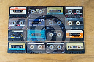 Cassette audio tapes on a wooden background