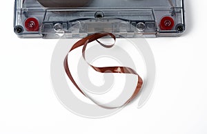 Cassette with a brown magnetic tape on a white background