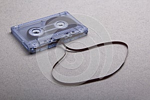 Cassette with removed tape on grey background photo