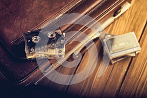 Cassette tape lying on an old suitcase.