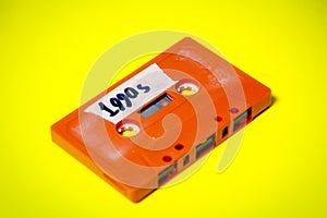 Cassette tape orange on yellow 1990s