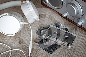 Cassette tapes, music player with white headphones. Retro style