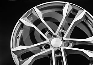 Cast disc, aluminum wheel close up. Polished front part and gray color. Auto parts close-up