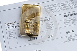 Cast gold bar weighing 250 grams on a background of a certificate