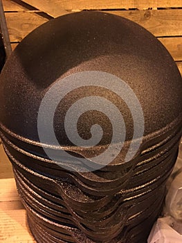 Cast iron cauldrons on each other in the warehouse