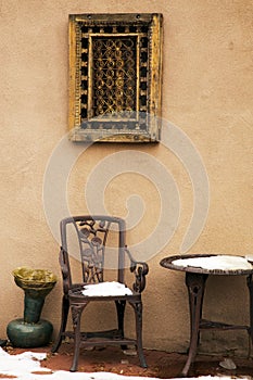 Cast Iron Chair and Table Under A Decorative Window Covering, Sa