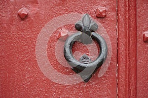 Cast iron door knocker on an old door.