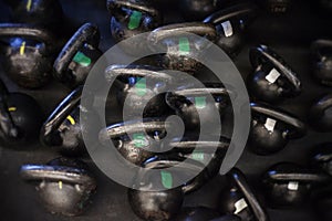 Cast iron kettle bells on the floor of a CrossFit Gym