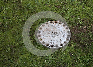 Cast iron lid on the lawn hides a secret trap of a passage to hi