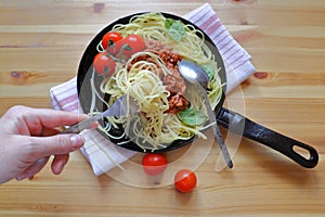 A cast iron pan filled with tomato sauce made from organic, heirloom tomatoes, resting on a piece of vintage salvaged slate, c