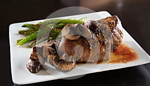 Cast iron pan seared tenderloin beef steak with portabella mushrooms photo
