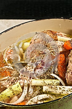 Cast iron pot filled with chicken and vegetables