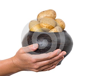 Cast iron pot with a potato in the hands