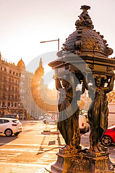 Cast iron public fountain with caryatid female figures in Barcelona