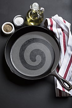 Cast Iron Skillet with copy area on black background with ingredients