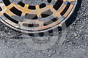 A cast-iron storm sewer hatch on the road before laying the asphalt pavement poured with bitumen. Drainage of rainwater from the
