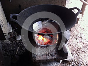 Cast iron wok on charcoal fire