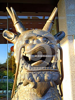 Cast metal head of a qilin