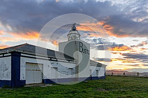 View of the Cabo de Busto lighthouse at sunset photo