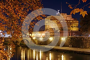 Castel Sant Angelo or the Mausoleum of Hadrian and Tiber River, at night - landmark attraction in Rome, Italy. Autumn background