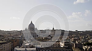 Castel Sant Angelo and Vatican city panorama on a cloudy winter day. People are visiting famous historic buildings in