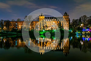 Castello del Valentino baroque castle seen from river Po during night in Turin, Italy...IMAGE