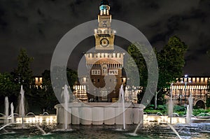 The Castello Sforzesco Medieval Castle Located in Milan, Northern Italy. Illuminated Historic Fortification with the Fountain