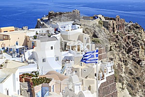 Castillo area with castle and byzantine ruins and greek flag in oia