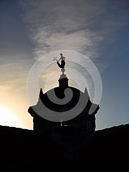 Castillo de Real Fuerza watchtower with La Giraldilla weathervane backlit against a cloudy evening sky. Havana, Cuba photo