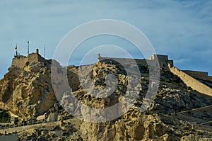 The Castillo de Santa BÃ¡rbara in Alicante on a rocky mountain under a clear blue sky