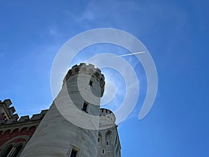 Castle with airplane contrail in background