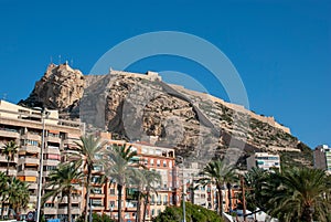 Castle of Alicante on mountain with big apartment building in front