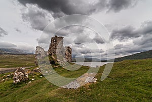Castle Ardvreck ruins under storm sky, Scotland.