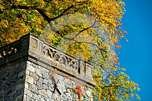 Castle balcony with yellow autumn fall tree