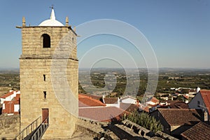 Castle bell tower with village in the background photo