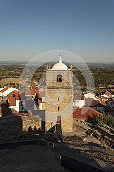 Castle bell tower with village in the background photo