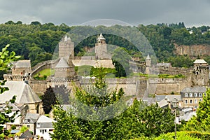 the castle of FougÃ¨res under a dark sky