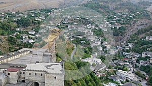 Castle of Gjirokastra and city center. Aerial view of ancient fortress Albania