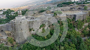 Castle of Gjirokastra and city center. Aerial view of ancient fortress Albania